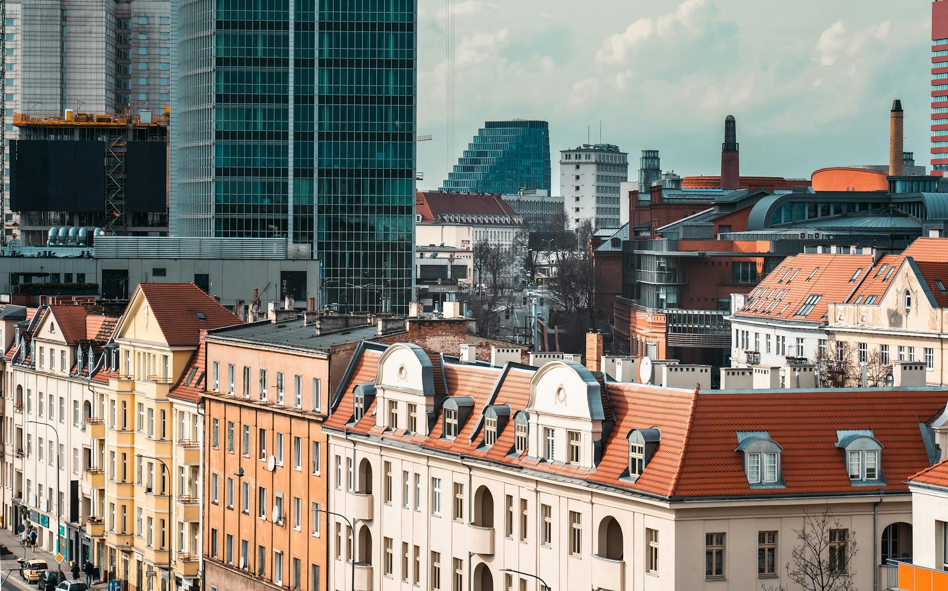 A vibrant cityscape of Poznań showcasing modern skyscrapers and historic architecture.
